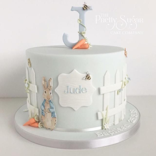 a white cake decorated with an image of a rabbit and the number one on it