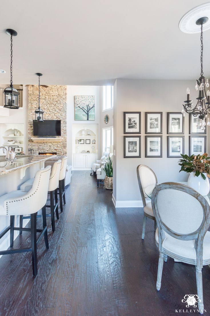 an instagramted photo of a kitchen and dining room with pictures on the wall