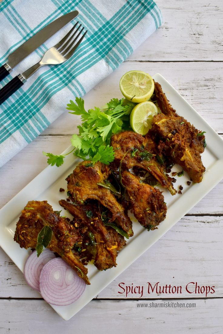 chicken wings with cilantro, parsley and lemon on a white platter