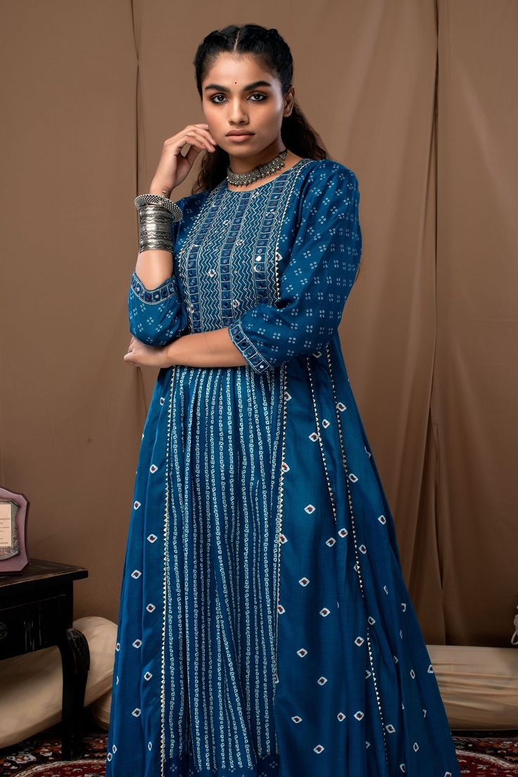 Blue anarkali in bandhani print with mirror and thread embroidery on the yoke. Paired with off-white cotton silk pant.
Component: 2
Pattern: Printed
Type Of Work: Bandhani
Neckline: Round
Sleeve Type: Straight Three Quarter
Fabric: Cotton Silk
Color: Blue
Other Details: 
Cutwork hem anarkali and pant
Occasion: Puja - Aza Fashions Floor-length Bandhani Print Kurta For Festive Occasions, Bollywood Style Bandhani Print Floor-length Kurta, Unstitched Chanderi Sharara With Bandhani Print, Traditional Chanderi Palazzo Set With Bandhani Print, Bandhani Print Chanderi Sharara For Diwali, Bollywood Style Designer Bandhani Print Salwar Kameez, Festive Bollywood Anarkali Set With Bandhani Print, Designer Chanderi Sharara With Bandhani Print, Designer Chanderi Salwar Kameez With Bandhani Print