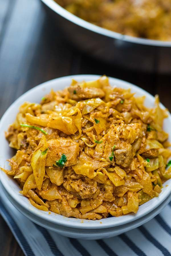 two bowls filled with food sitting on top of a table