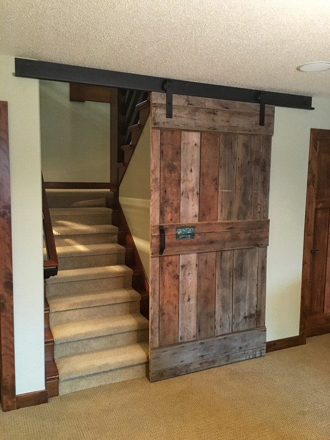 an open door leading to a stairway in a house with carpeted flooring and stairs