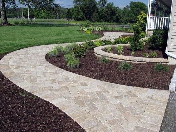 a brick walkway in front of a house