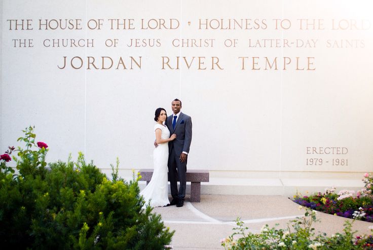 a bride and groom standing in front of the jordan river temple