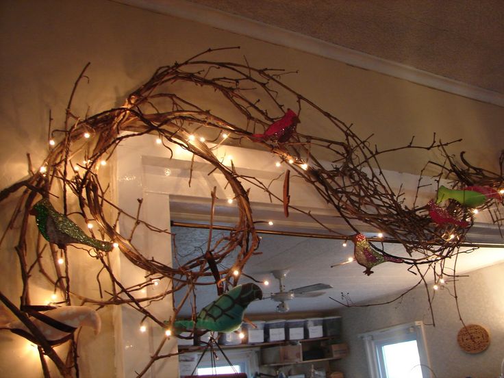 the branches have been decorated with lights and birds