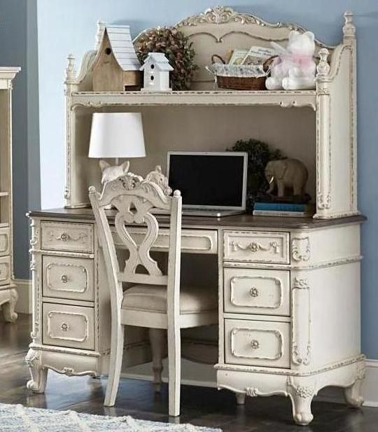 an antique desk and chair in a room