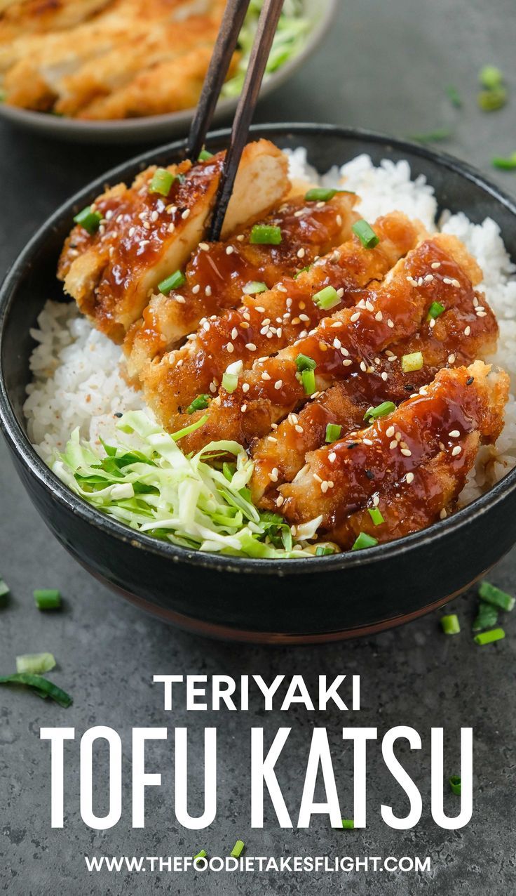 two bowls filled with food and chopsticks on top of rice