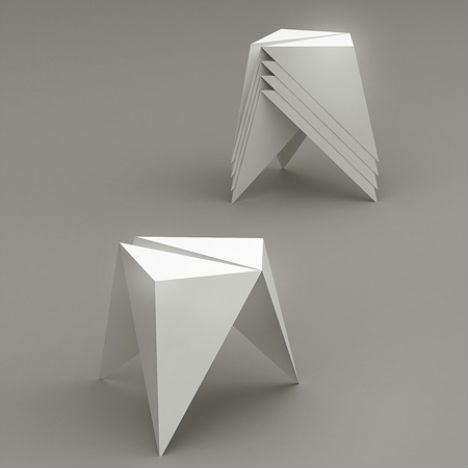 three white origami shaped objects sitting on top of each other in front of a gray background