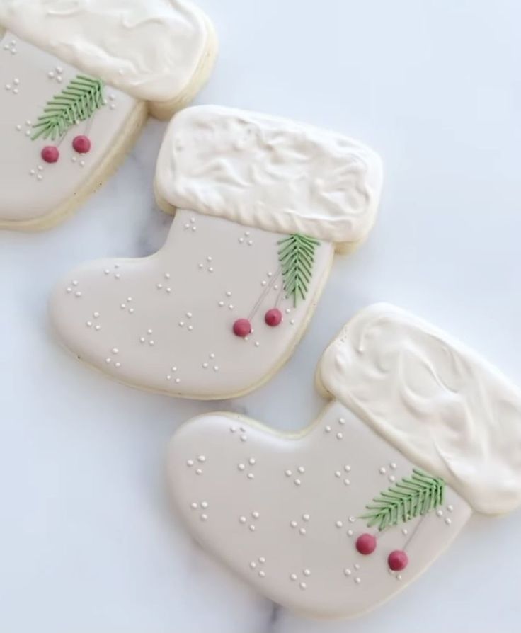 three decorated cookies sitting on top of a table