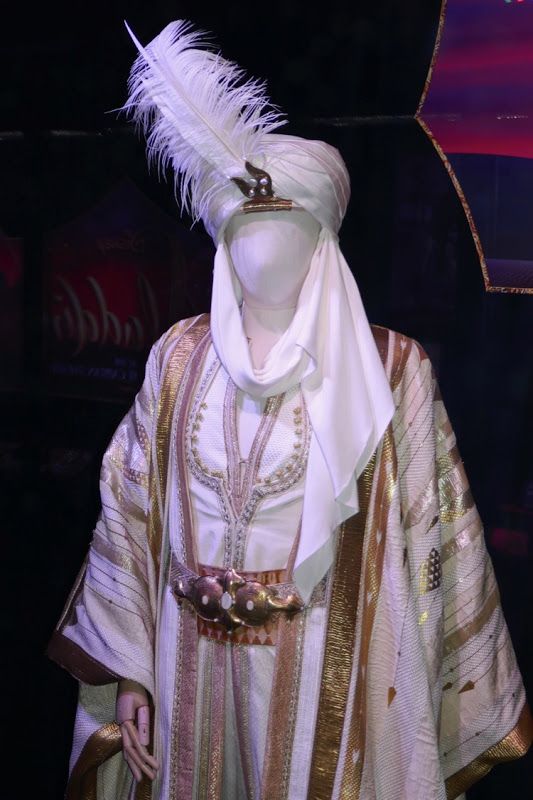 a mannequin dressed in white and gold clothing