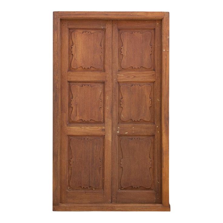 an old wooden door with carved designs on the front and side panels, isolated against a white background