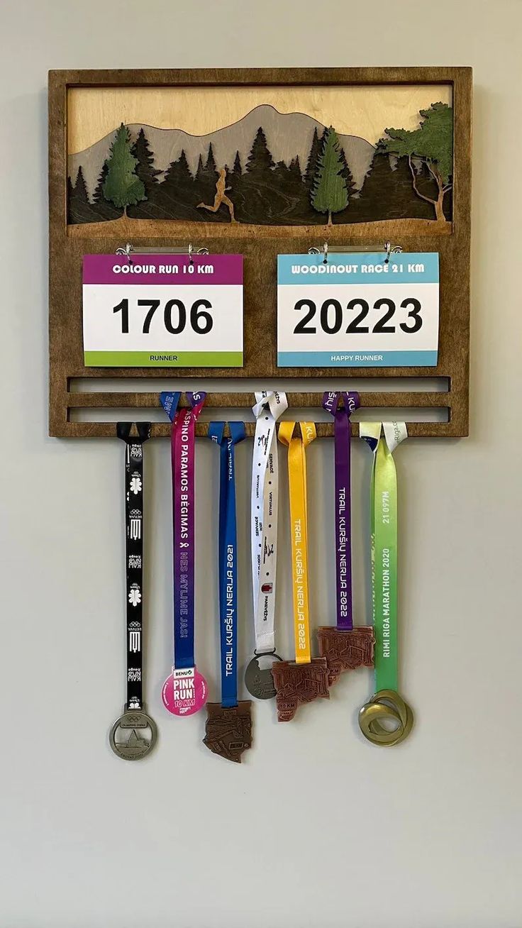 a wooden medal holder with medals hanging from it's sides