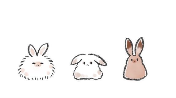 three different colored rabbits sitting next to each other