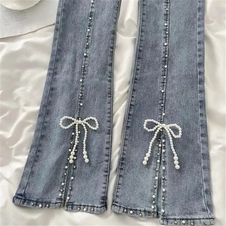 You'll look as precious as pearls in these Beaded Split Bow Jeans! These jeans offer an exciting twist on a timeless classic, with intricate beaded detailing along with a split seam to give your outfit a unique, eye-catching look. Size Chart: Size Waist (cm) Hip (cm) Length (cm) Waist (in) Hip (in) Length (in) S 63 72 94 24.80 28.35 37.01 M 67 76 94 26.38 29.92 37.01 L 71 80 95 27.95 31.50 37.40 XL 75 84 95 29.53 33.07 37.40 XXL 78 85 96 30.71 33.46 37.80 Description: Item Type: JeansJeans Style Jean Sketch Fashion, Customize Jeans Diy, Jeans With Beads, Beaded Jeans Diy, Beads On Jeans, Pearls On Jeans, Elegant Denim Blue Jeans, Spring Elegant Flare Denim Jeans, Elegant Spring Denim Flare Jeans