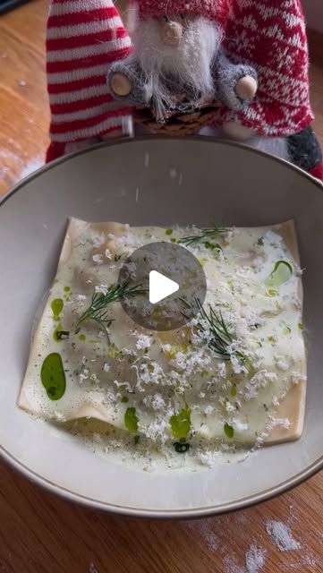 a white plate topped with food on top of a wooden table next to a gnome