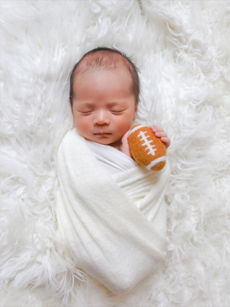 Football themed newborn shoot. 3 weeks old. Baby Football Pictures, Newborn Football, Baby Boy Football, Newborn Family Pictures, Baby Boy Newborn Pictures, Newborn Baby Photoshoot, Football Baby, Newborn Baby Boy, Football Photos