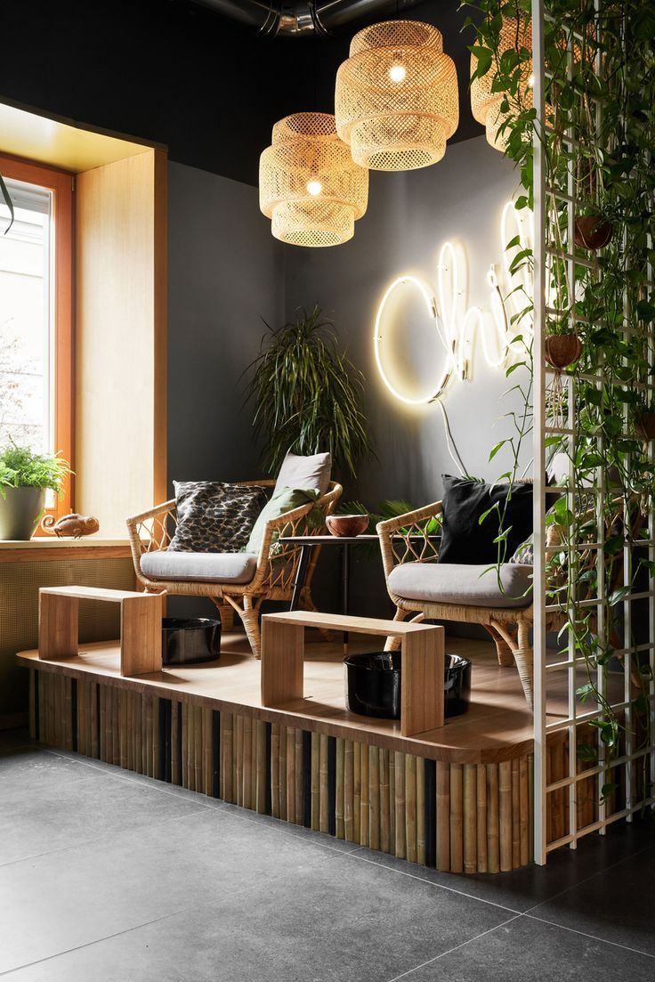 a living room filled with furniture and plants