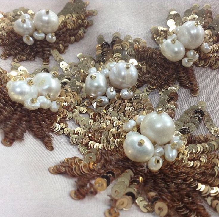 several pieces of gold and white broochies with pearls