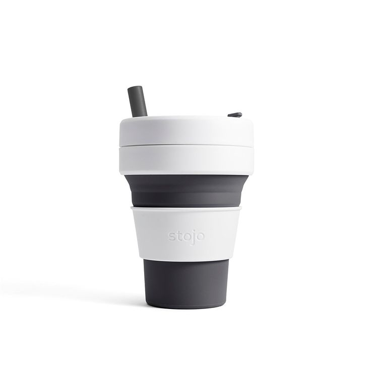 a white and black coffee cup sitting on top of a table