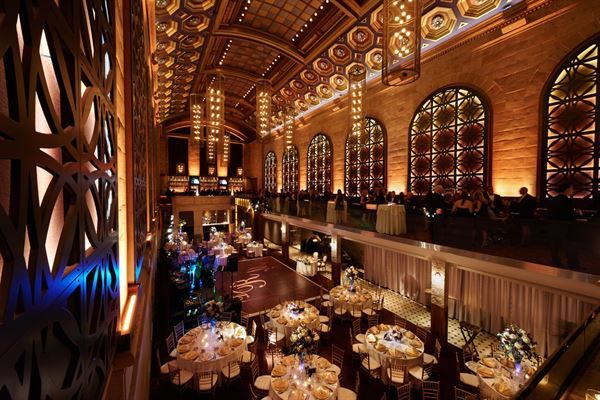 the inside of a restaurant with tables and chandeliers hanging from the ceiling above