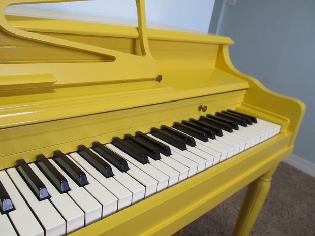 a yellow piano with black and white keys