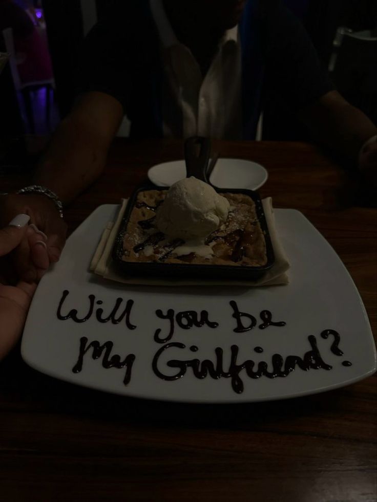 a birthday cake that says will you be my girlfriend?