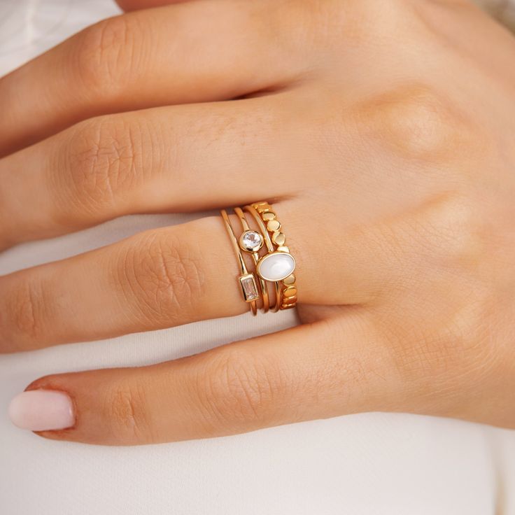 A small, delicate Gold Petite Oval Pearl Ring is a delightful, feminine choice. Crafted from eco-friendly recycled gold and a sustainable gemstone, it is the perfect accessory to pair with any Sara Patino Jewelry look. The soft and luminous white pearl offers a timeless beauty that is both classic and modern. Mother of Pearl is 6mm x 4mm Recycled 14k gold over sterling silver (vermeil) Delicate Everyday Pearl Ring, Delicate Gold Moonstone Ring For Everyday, Delicate Stackable Pearl Ring For Everyday, Delicate White Pearl Ring For Everyday Wear, Delicate White Moonstone Ring For Everyday, Everyday Delicate White Moonstone Ring, Delicate White Stackable Rings For Everyday, Delicate Everyday White Stackable Rings, Delicate White Stackable Rings