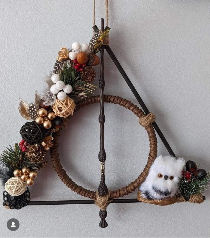 a christmas wreath hanging on the wall with two stuffed animals in it's center