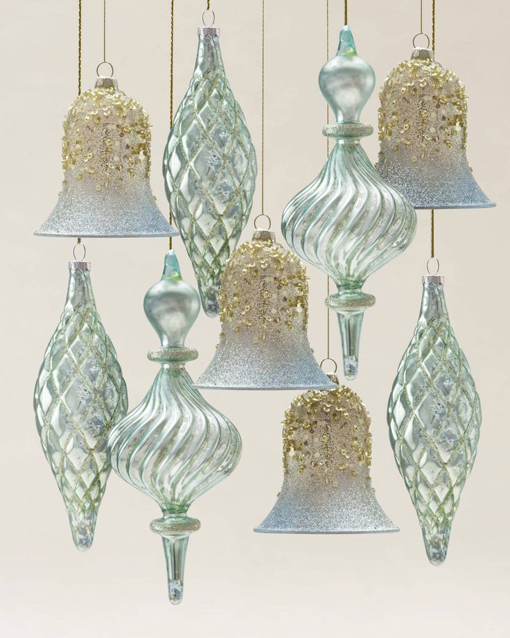 a group of glass ornaments hanging from strings