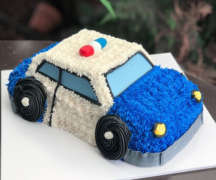 a cake shaped like a police car on top of a table