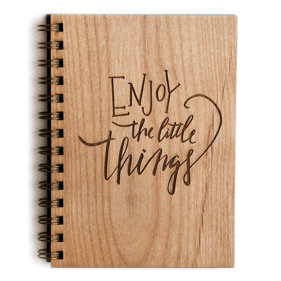 a wooden notebook with the words amazing things will happen written on it in cursive writing