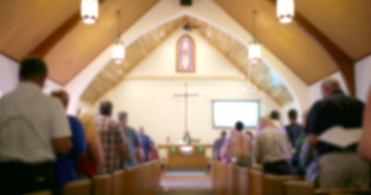 blurry photograph of people in church pews