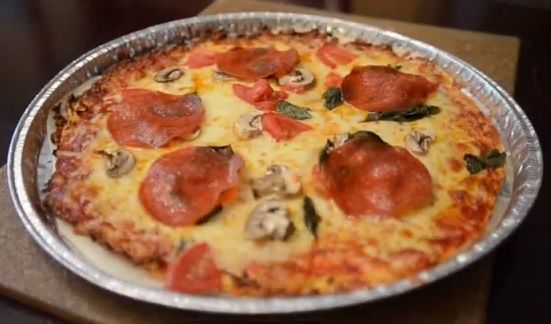 a pizza sitting on top of a pan covered in cheese and pepperoni toppings