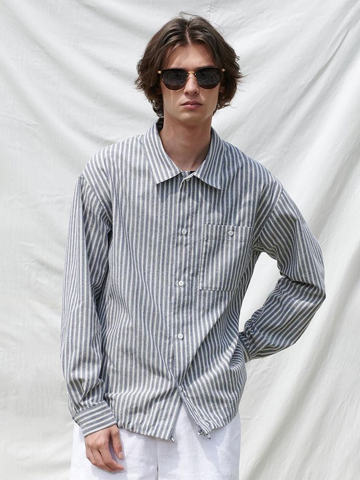 The shirt features new stripe pattern. The shirt has patch pocket on the chest and drawcords on the hem to style in various ways. Made of cotton blend fabric, the shirt is wrinkle-resistant and has refreshing touch.- Basic item- Oversized fit- Side slits- Soft, comfy Casual Pinstripe Shirt For Work, Casual Shirt With Striped Collar, Casual Shirt With Striped Collar For Everyday, Everyday Striped Collared Shirt, Pinstripe Cotton Tops With Relaxed Fit, Striped Collared Shirt With Pockets, Everyday Cotton Shirt With Striped Collar, Casual Pinstripe Tops With Pockets, Relaxed Fit Pinstripe Cotton Tops