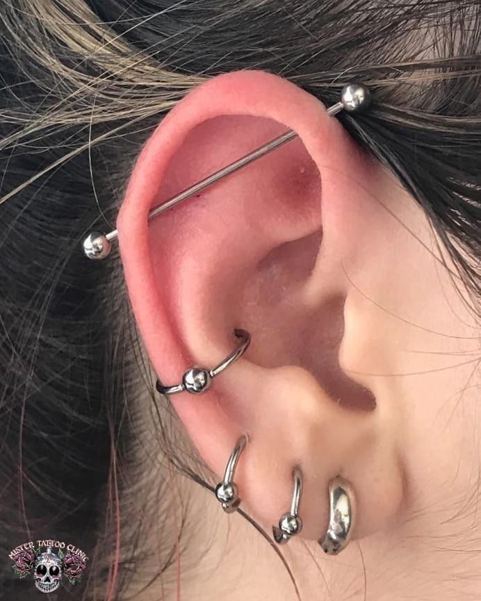 an ear with three piercings attached to it