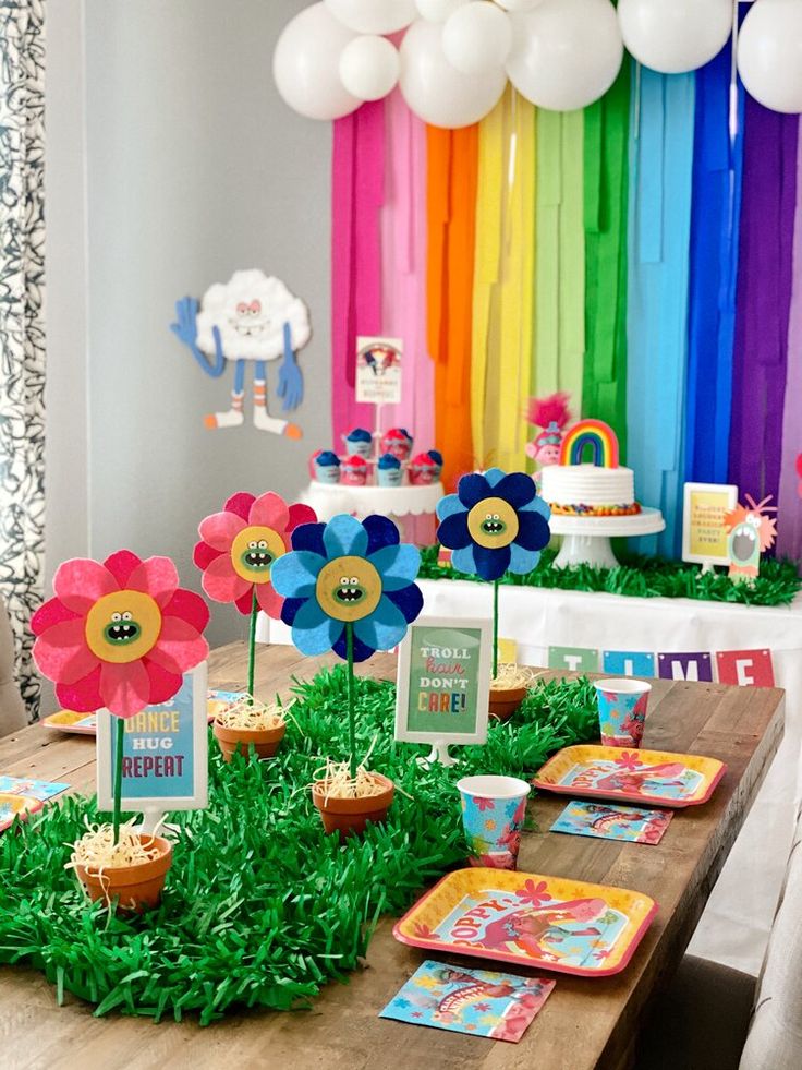 a table topped with lots of cake and cupcakes on top of wooden tables