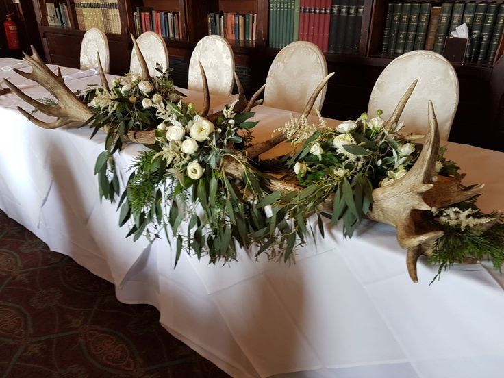 the table is decorated with antlers and flowers