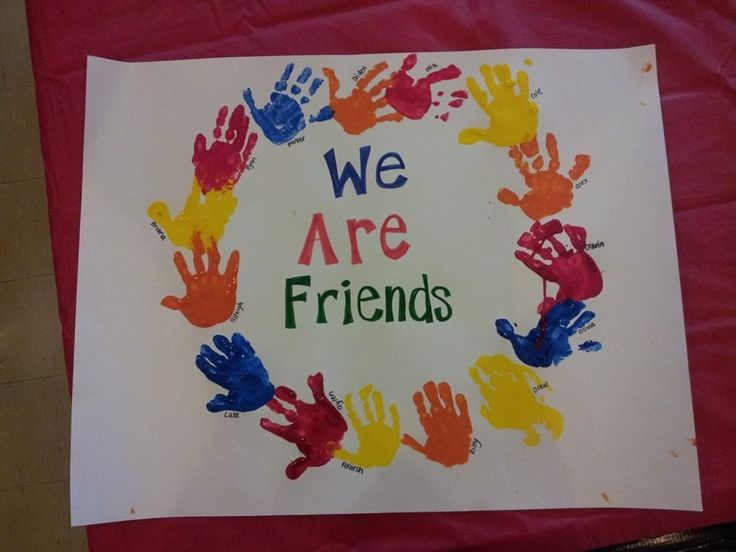 there is a sign that says we are friends with hand prints in the shape of a circle