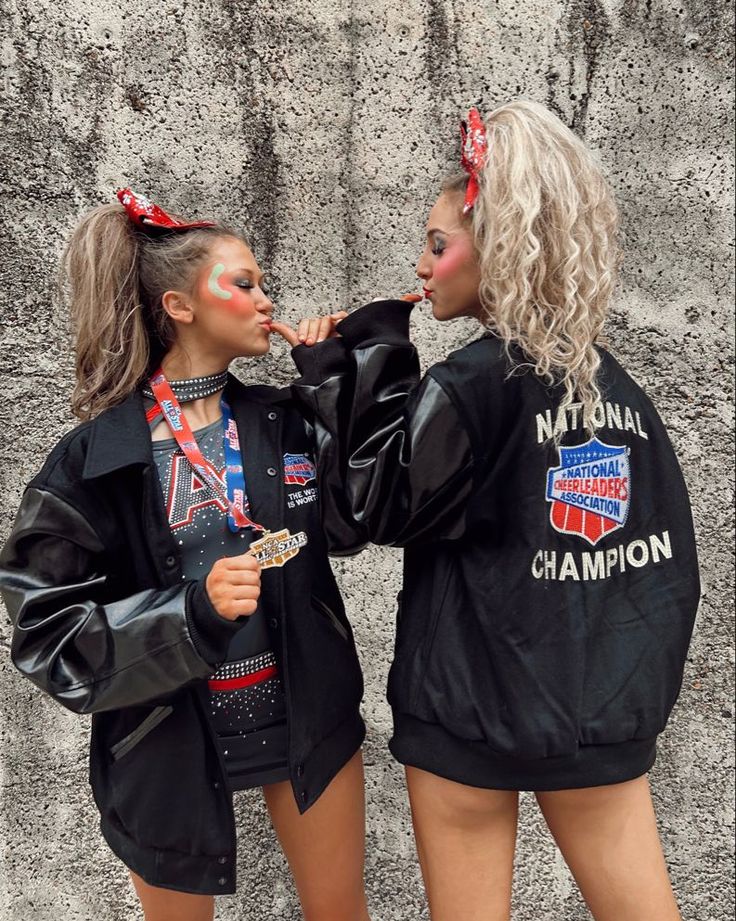 two women with makeup on their faces are standing next to each other