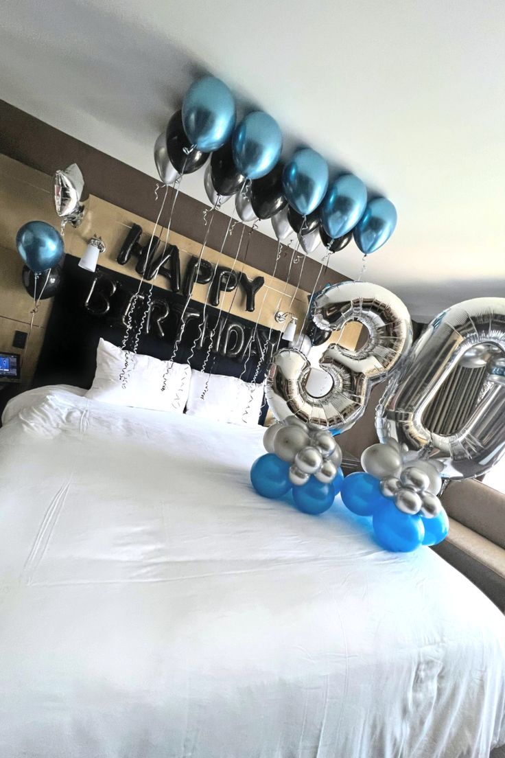 balloons are floating in the air on top of a bed