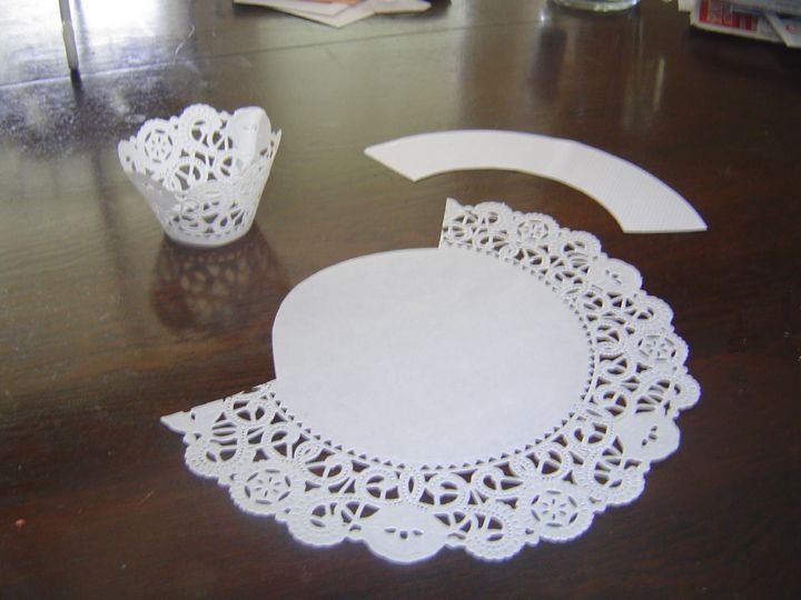 paper doily cut out to look like an ornament on a wooden table