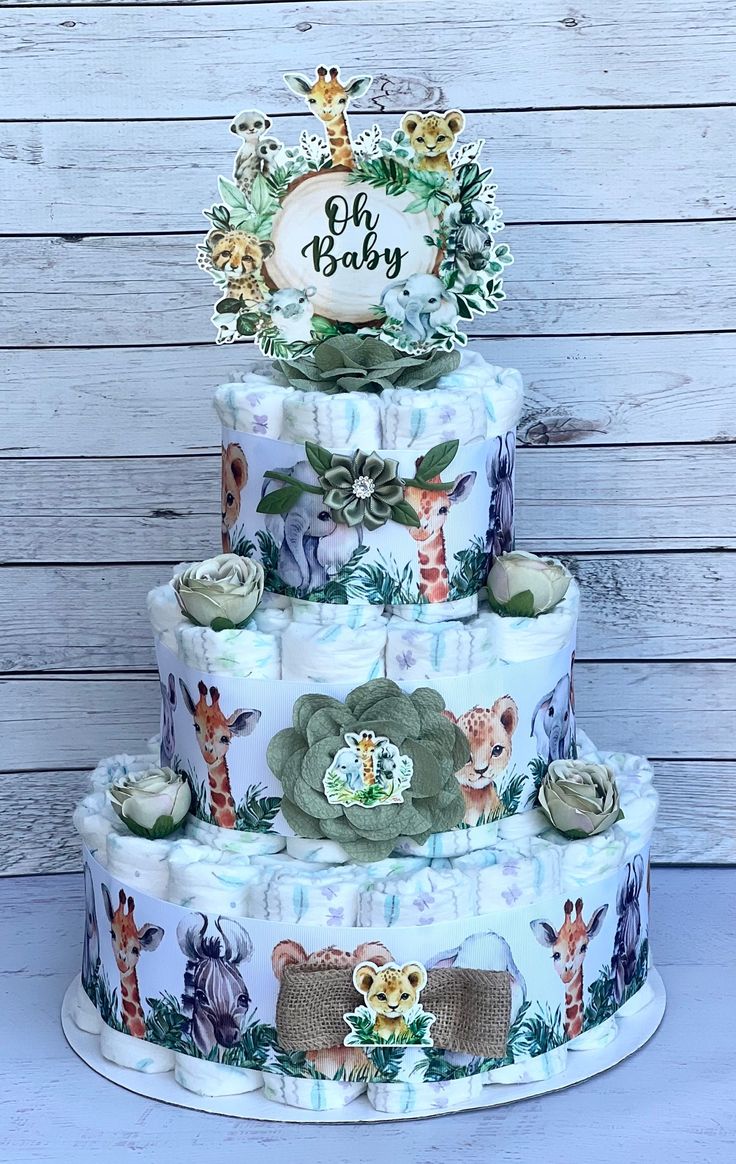 a three tiered cake with giraffes on it