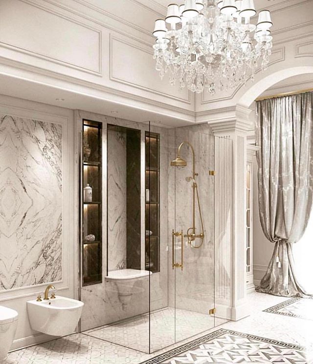 an elegant bathroom with marble walls and floors