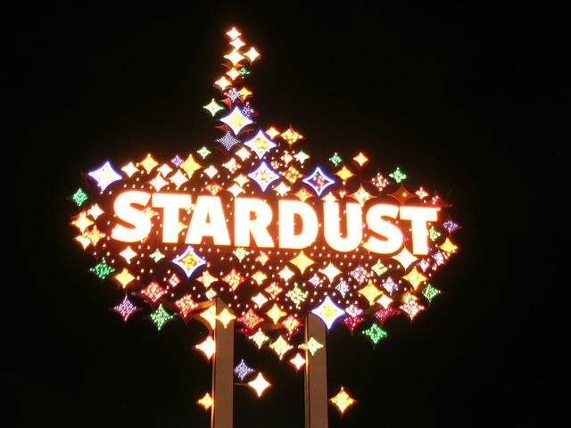 the stardust sign is lit up at night