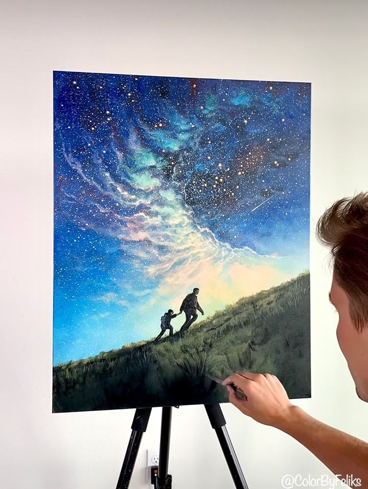 a man is painting on an easel while looking at the stars in the sky