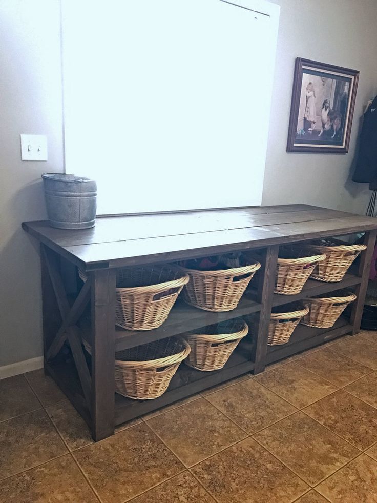 an entryway bench with baskets on it