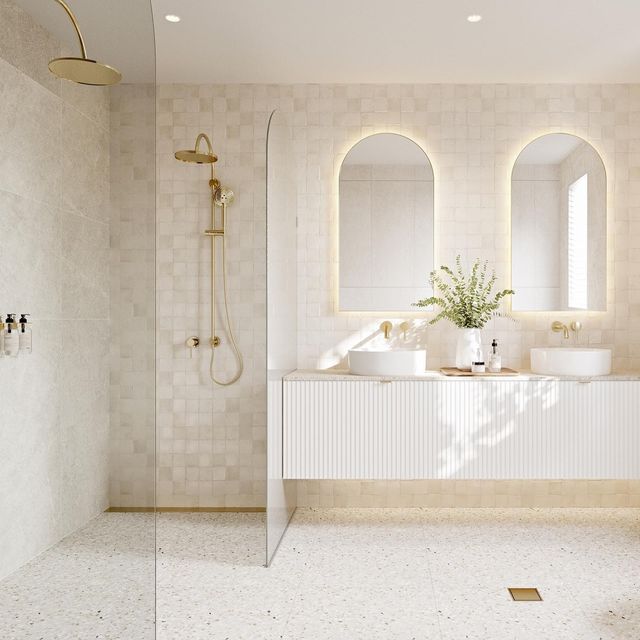 a bathroom with three sinks and two mirrors on the wall, along with a walk in shower