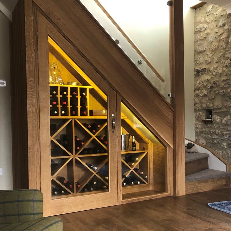 a wine cellar under the stairs in a house