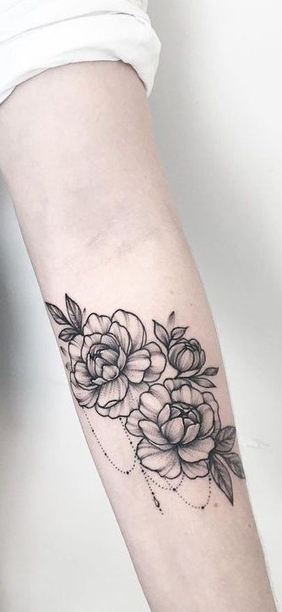 a woman's arm with flowers on it