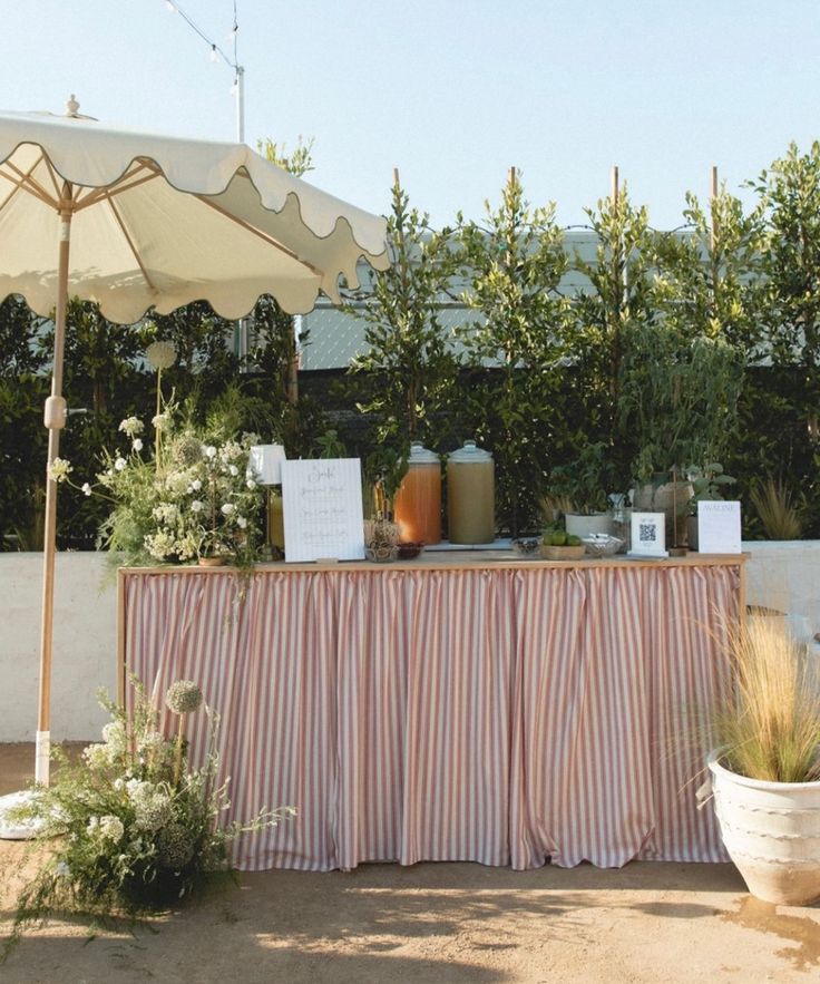 a table with an umbrella and flowers on it